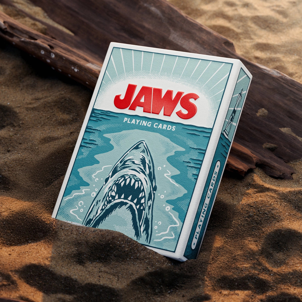 Jaws playing cards packaging on a sandy background