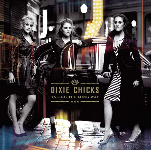 Album cover for 'Taking the Long Way' by Dixie Chicks featuring three women on a city street.