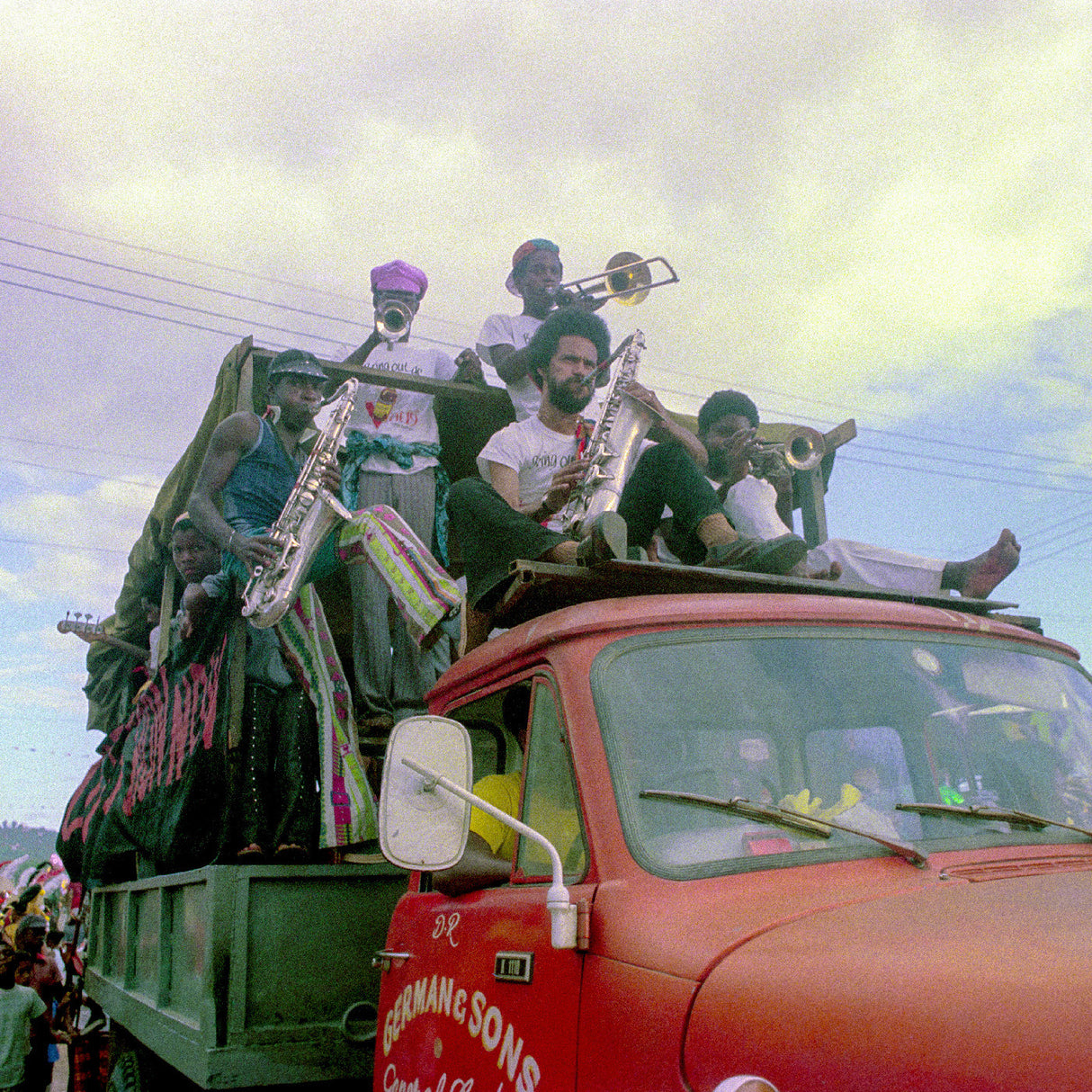 People with musical instruments on a truck in a colorful setting