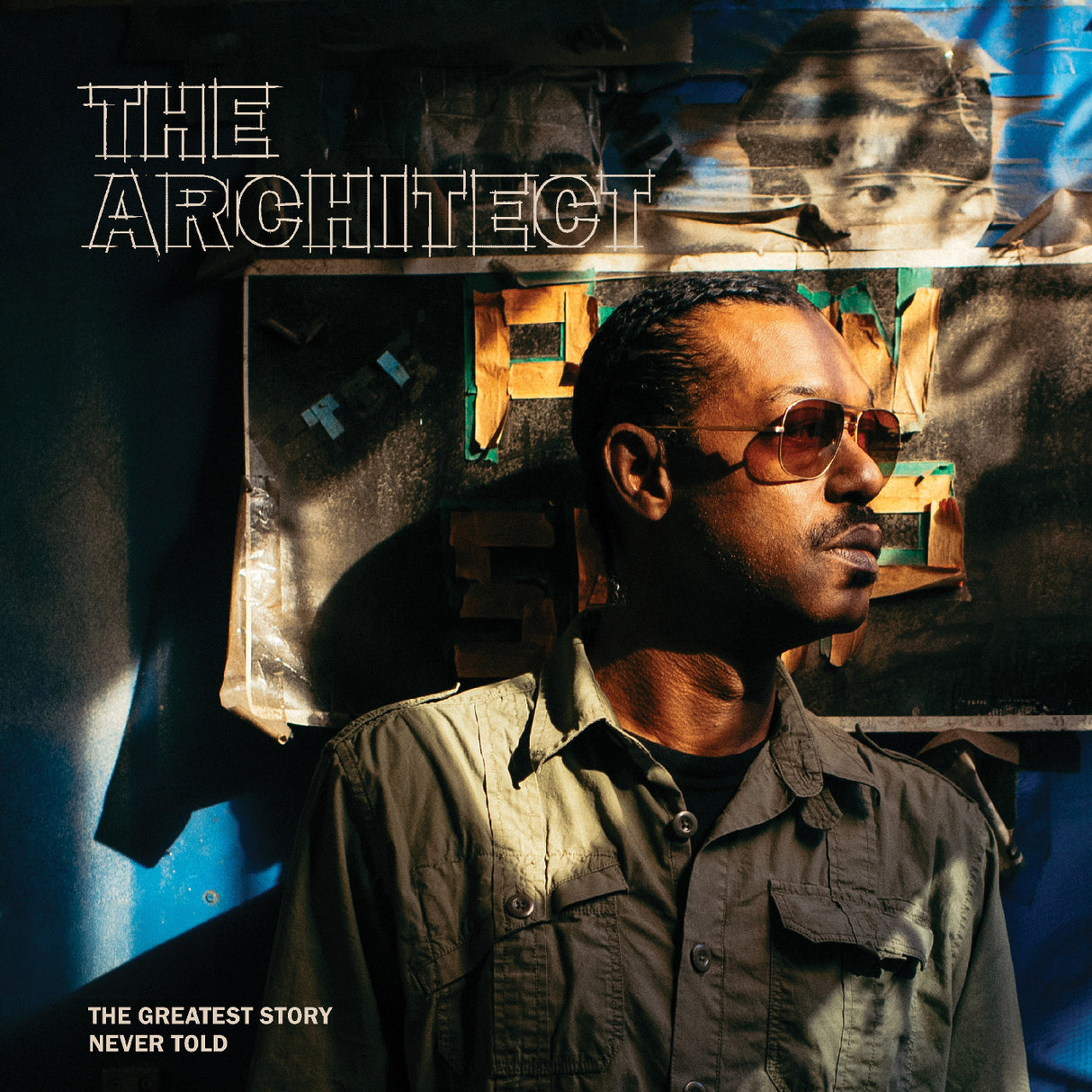 Man wearing sunglasses with a textured wall and abstract art in the background, featuring text 'The Architect' and 'The Greatest Story Never Told'.