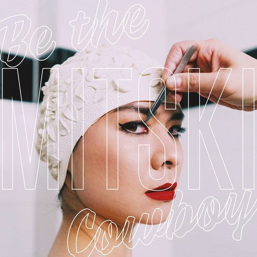 CD cover featuring a close-up of a person with red lipstick, overlaid with white text spelling out 'MITSKI' and 'Cowboy'.
