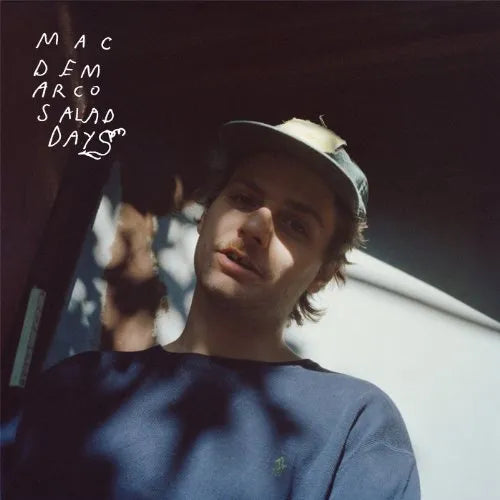 Album cover with a person wearing a cap and text 'Mac Demarco Salad Days' on a dark background