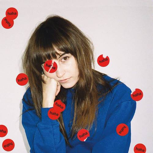 A person with a contemplative expression sitting in front of a background filled with red 'haha' text cards.
