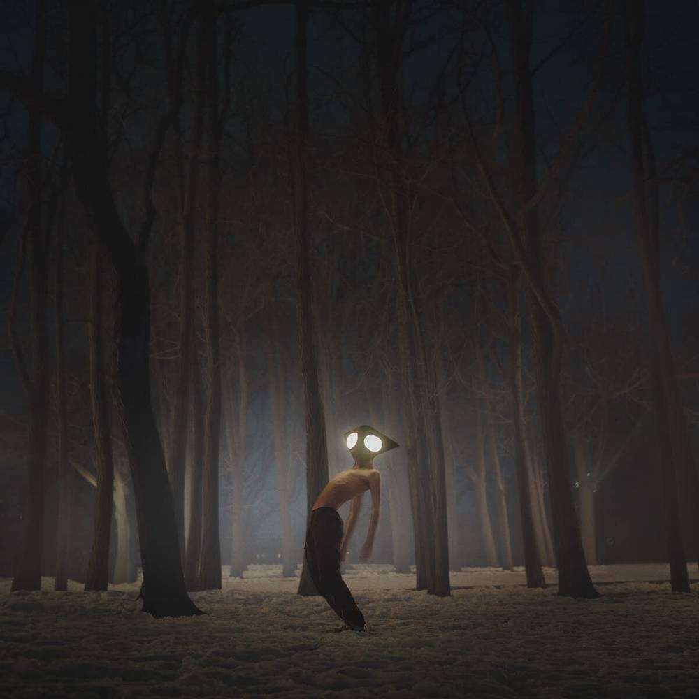 Person with glowing eyes in a dark forest