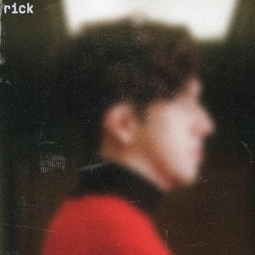 Blurred profile of a person wearing a red garment with 'rick' text at the top.