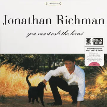 Album cover with a person and dog outdoors, featuring Jonathan Richman's 'You Must Ask the Heart' on a white background.
