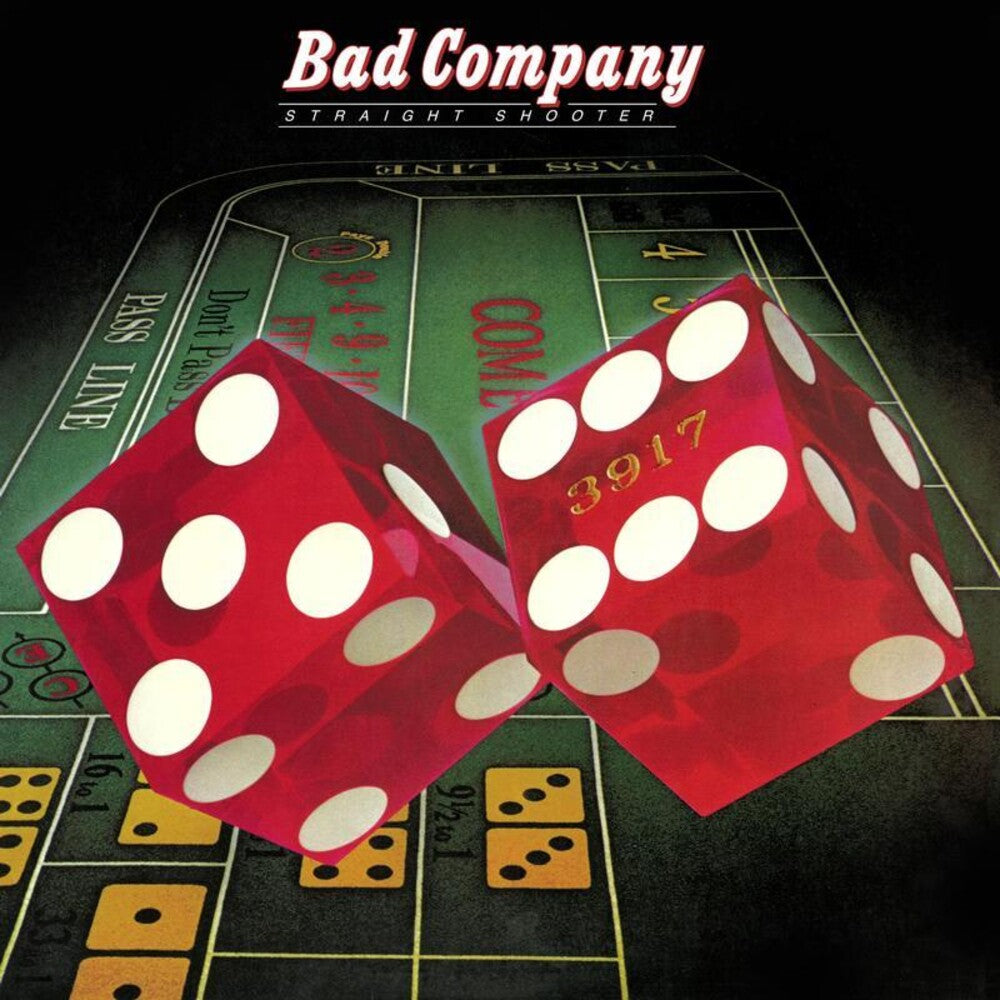 Two red dice with white dots on a craps table, featuring 'Bad Company' album cover.