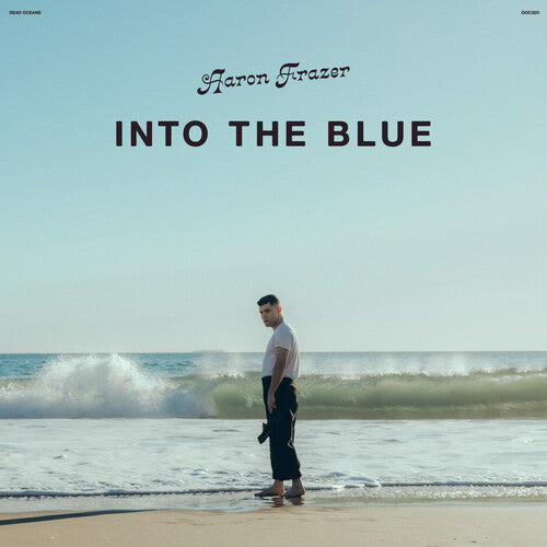 Aaron Frazier standing on a beach looking out to the ocean, with the title 'Into The Blue' written above.