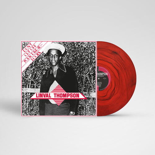 Vinyl record with red disc and black and white cover featuring a person, on a light gray background.