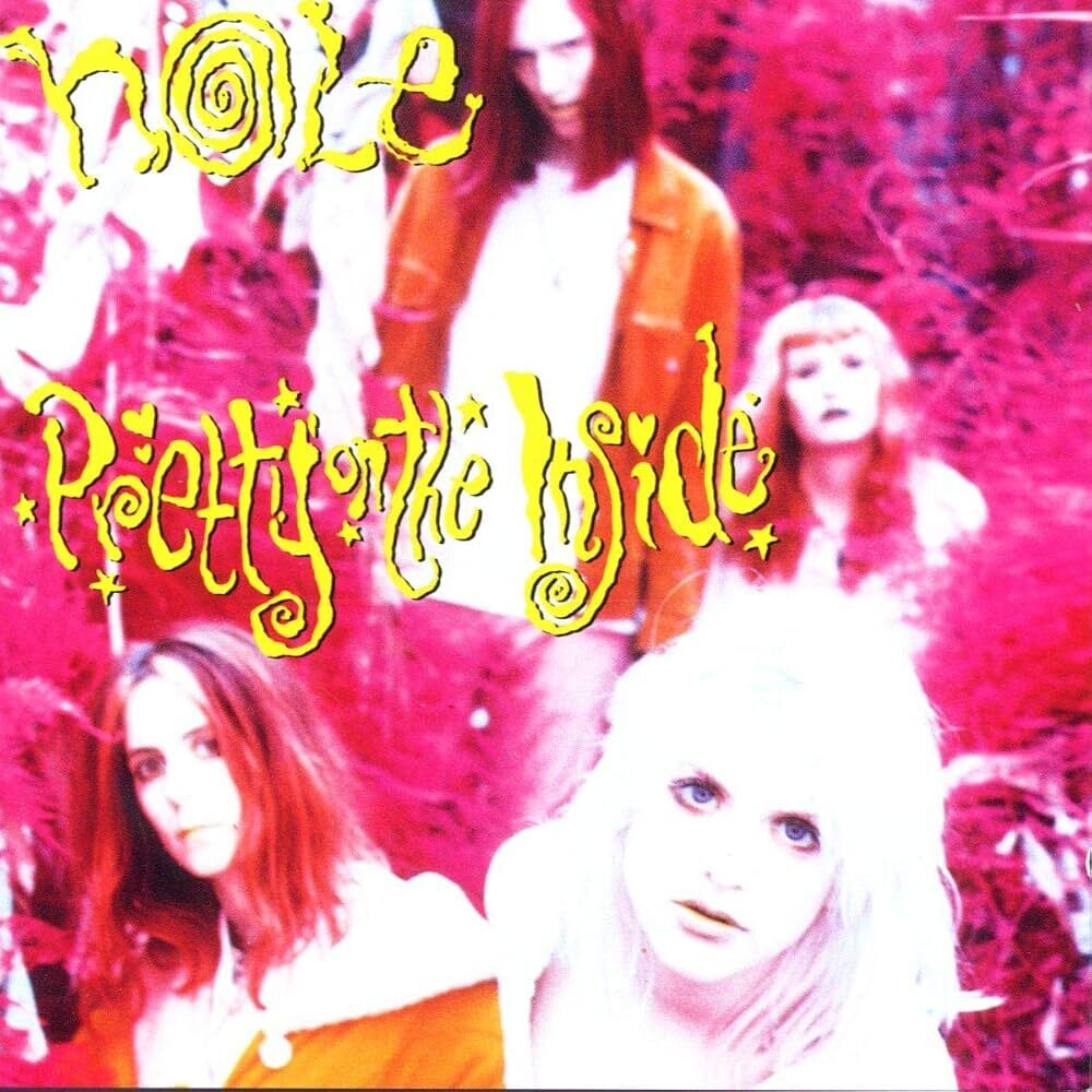 Album cover art for 'Pretty in Pink' by the band Noite, featuring stylized yellow text over a vibrant pink, high-contrast photograph of four band members.