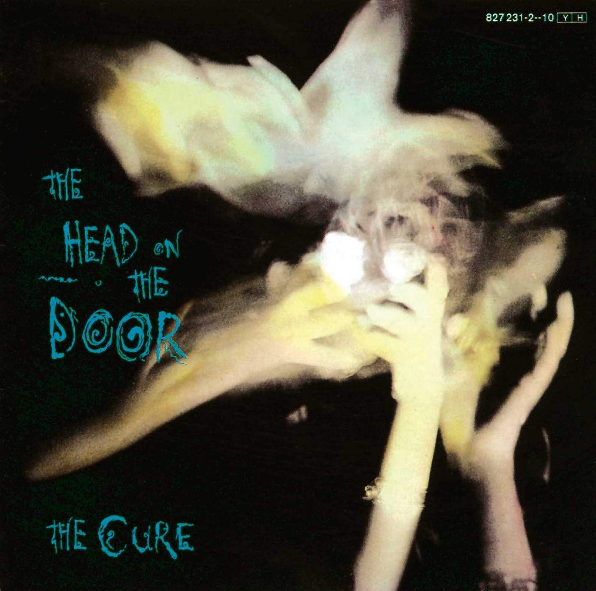 Album cover for 'The Head on the Door' by The Cure featuring a person with a bird on their head.