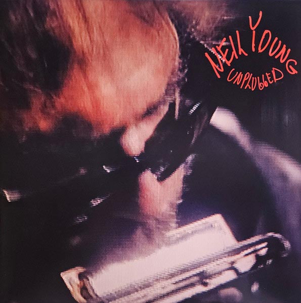 Album cover with a person playing harmonica, text 'Neil Young Unplugged' in red.