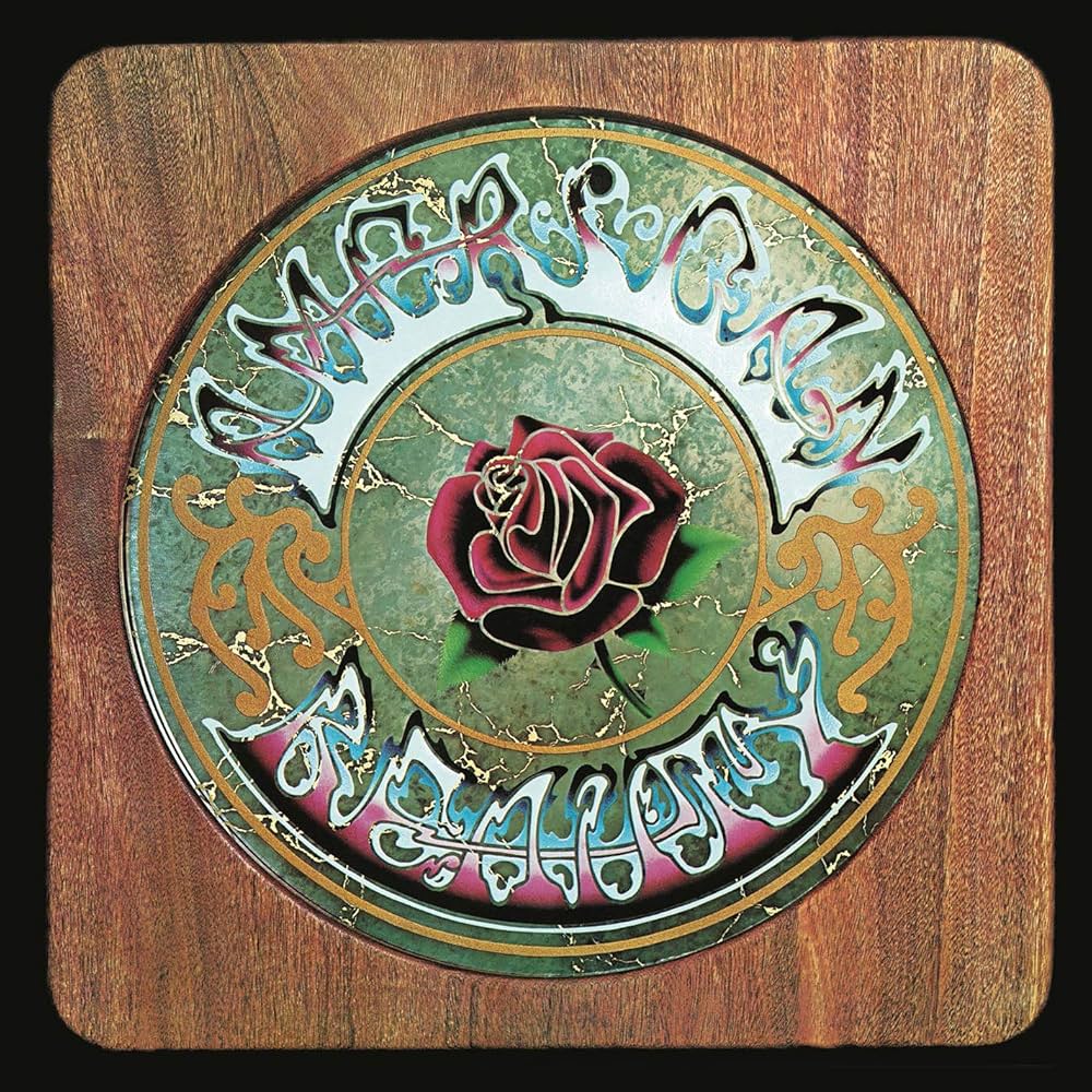 Decorative plate with a rose and ornate text on a wooden background