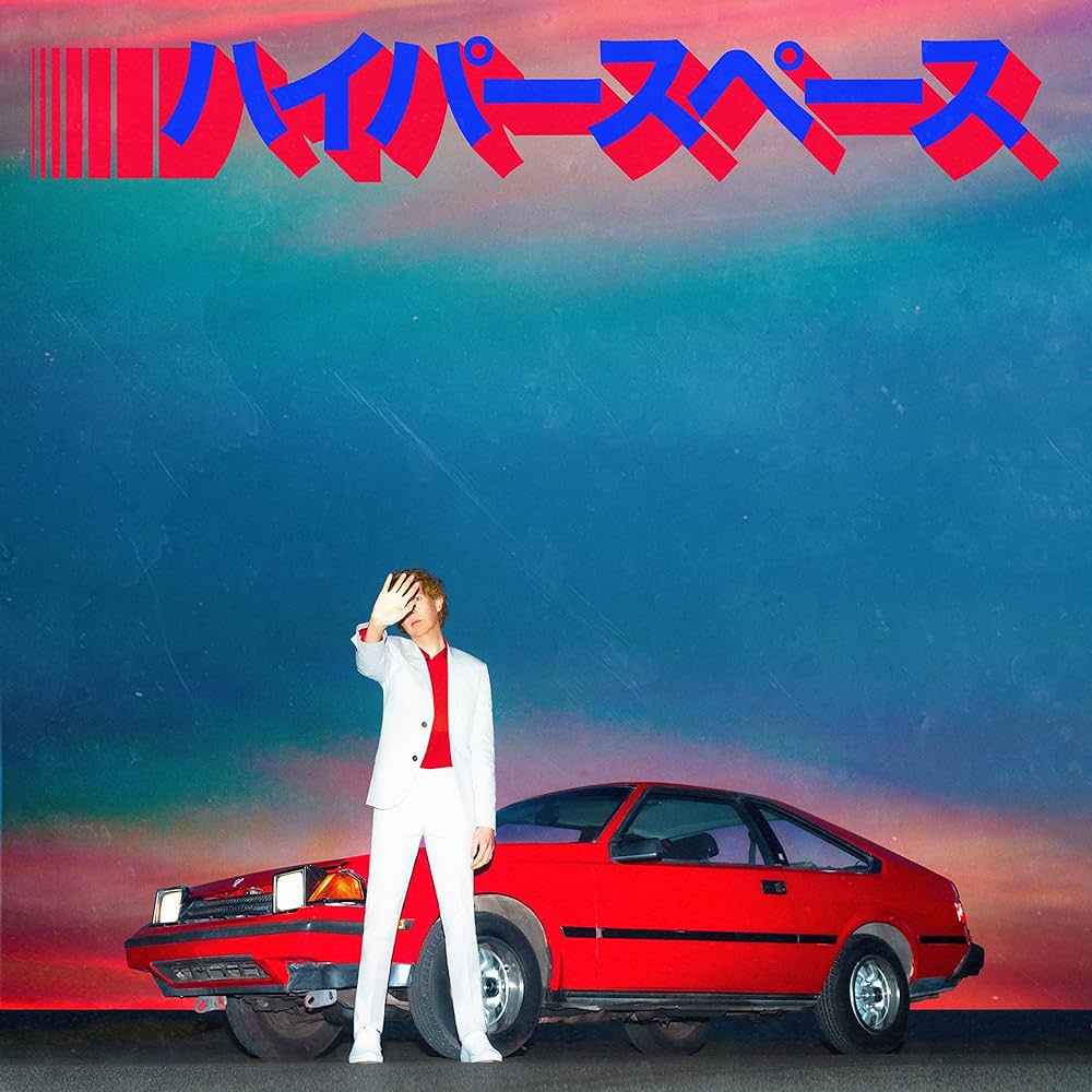 Person in a white suit standing next to a red car with Japanese text and colorful gradient sky.