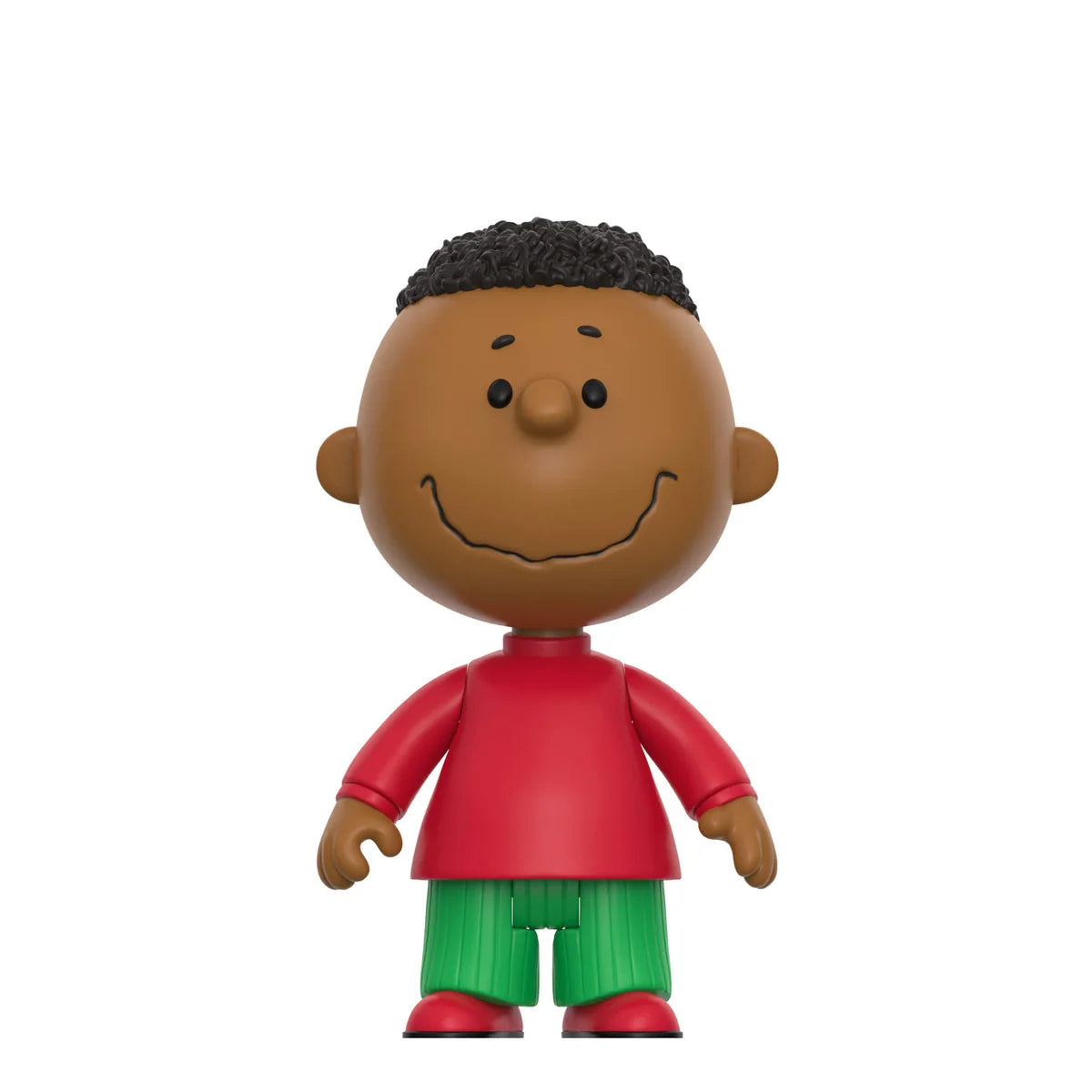 A stylized vinyl figure of a cartoon boy with brown skin, black curly hair, a red shirt, and green pants, centered on a plain white background.