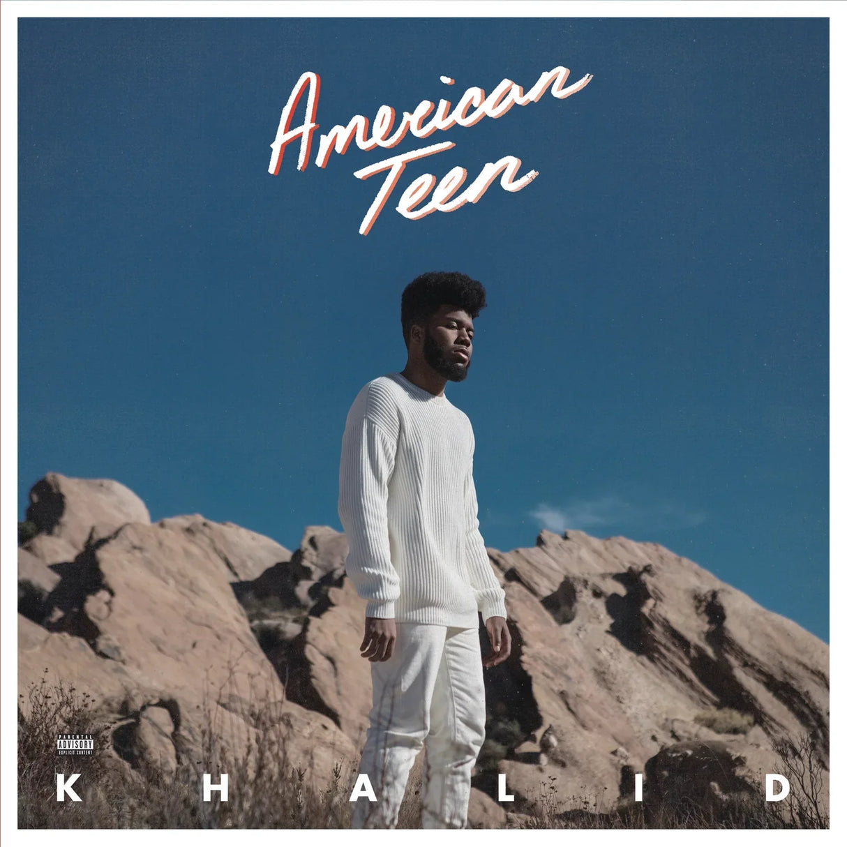 Album cover with a person standing on rocky terrain under a clear blue sky, featuring the text 'American Teen' and 'Khalid'.
