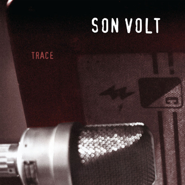 Close-up of a microphone with 'Son Volt' and 'Trace' text on a dark background
