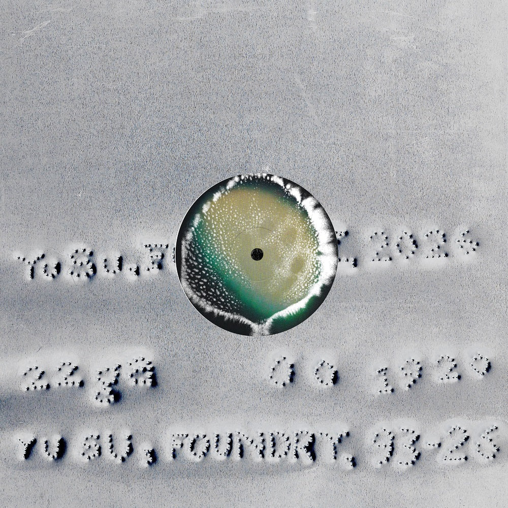 Close-up of a circular object with text around it on a textured surface