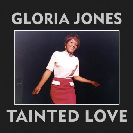 Cover art for Gloria Jones' 'Tainted Love' 7-Inch vinyl featuring a photo of Gloria Jones in a white top and red skirt, with the title text added.