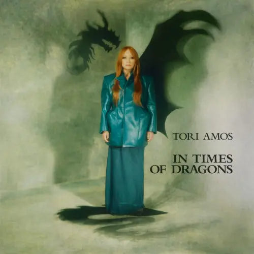 Album cover with a person in a teal outfit standing in front of dragon wings, with text 'Tori Amos In Times of Dragons'.