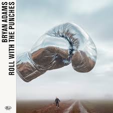 Album cover with boxing glove and person in a field, featuring text 'Roll with the Punches' by Bryan Adams.