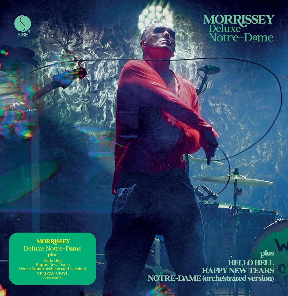 Album cover featuring a person in a red shirt on stage with musical instruments.