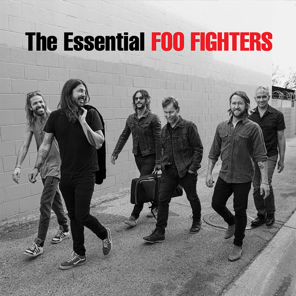 A black and white photo of the Foo Fighters band members walking and posing for a album cover