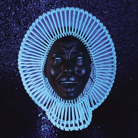 Album cover art featuring a stylized, artistic representation of a face with a blue and black color scheme and geometric patterns.