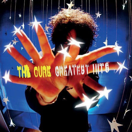 Album cover for The Cure's Greatest Hits featuring a person with stars around them against a dark background.