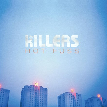 Album cover for The Killers - Hot Fuss featuring text and city lights against a blue background.