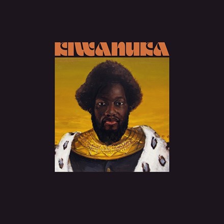 Album cover for Michael Kiwanuka's 'Kiwanuka LP' featuring a portrait of Michael Kiwanuka with an afro in a traditional outfit against a warm yellow and orange background.