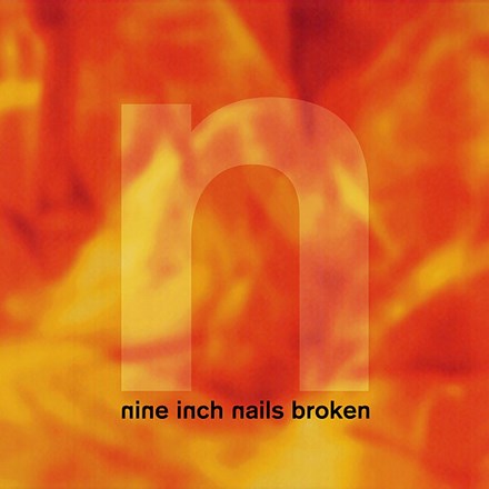 A vinyl record cover with a fiery background and the text 'Nine Inch Nails Broken' prominently displayed in the center.
