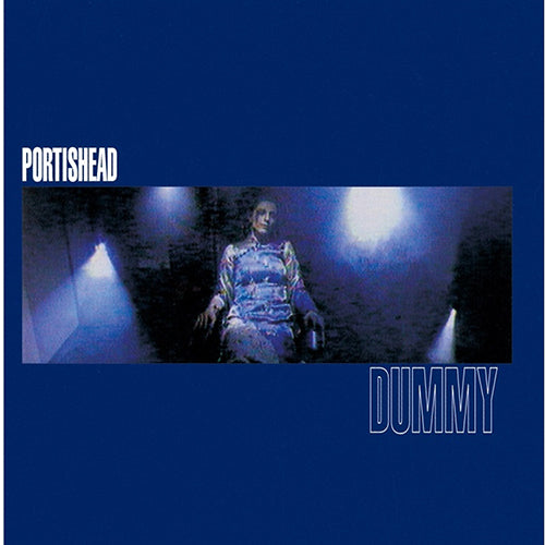 The album cover for Portishead's 'Dummy' featuring a person sitting in a chair with a blue backdrop and stage lights.