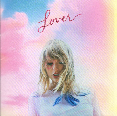 Taylor Swift album 'Lover' cover art featuring Taylor Swift's face with a colorful sky background.
