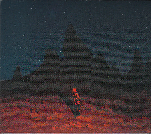 CD cover art featuring a person standing on a reddish-brown landscape with night sky and silhouette of rock formations in the background.
