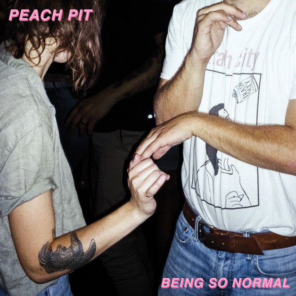 Album cover featuring two individuals, one with a tattoo on their arm, holding hands. The text 'PEACH PIT' and 'BEING SO NORMAL' is visible.