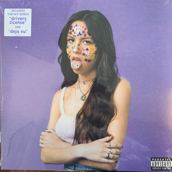 Olivia Rodrigo album Sour LP with her face covered in colorful dots, holding a record, against a purple background.