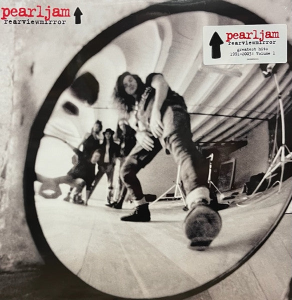 Black and white album cover of Pearl Jam with a mirror reflecting a performance scene, including the band and a camera.
