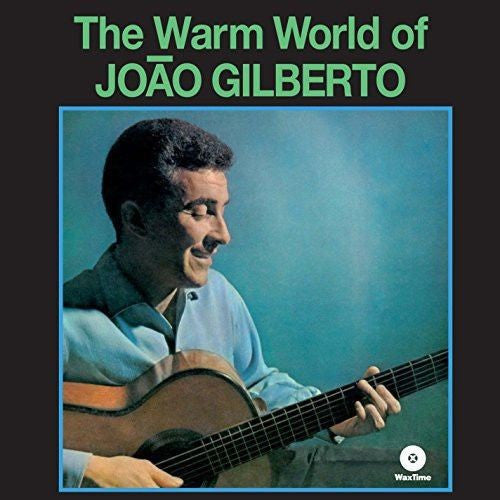 Cover of the album 'The Warm World of JOÃO GILBERTO' featuring a photograph of the artist, João Gilberto, smiling and playing a guitar.