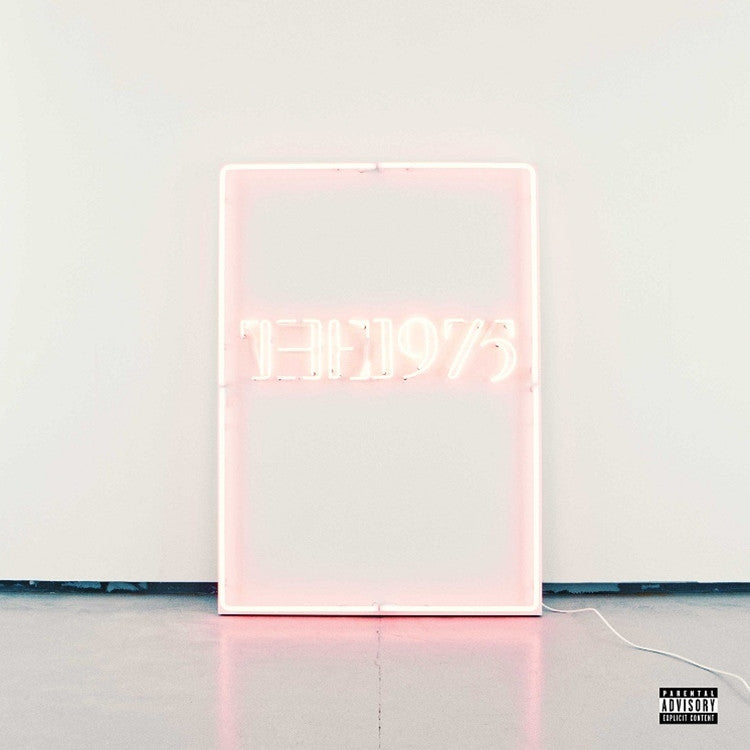 Neon sign with the text 'the 1975' in pink on a white background, likely representing a musical artist or group.