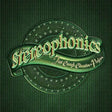 A green metallic pinback badge featuring the word 'stereophonics' in stylized lettering on a ribbon, with 'Just Enough Education - Person' written below, set against a dark green textured background.