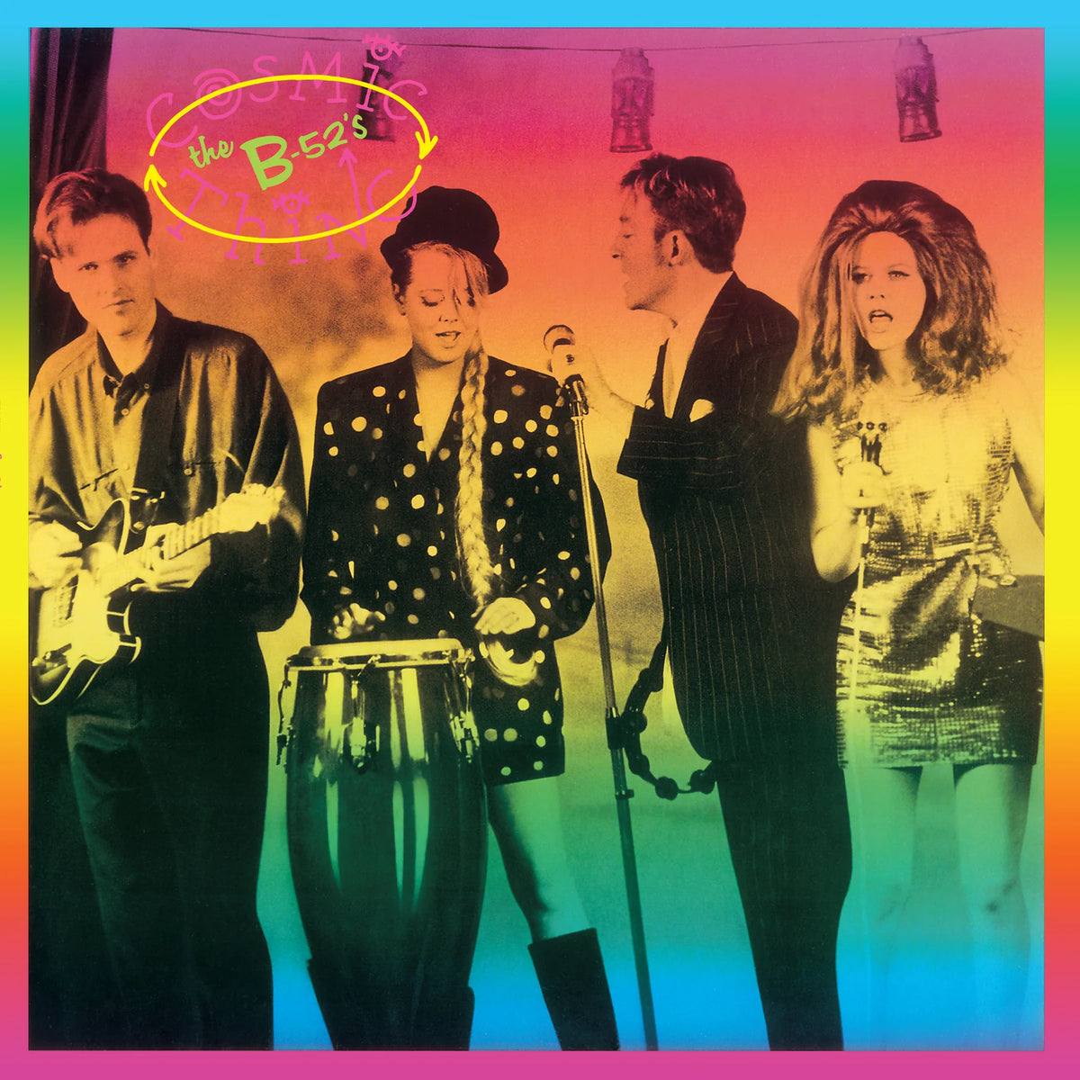 The Bee's 'Cosmic City' album cover featuring four band members performing on stage under a vibrant pink, orange, yellow, and blue gradient.