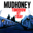 Album cover for Mudhoney's 'Tomorrow Hit Today', featuring a blue-toned photograph of a deserted street between white buildings, with the band's name in black and the album title in red text.