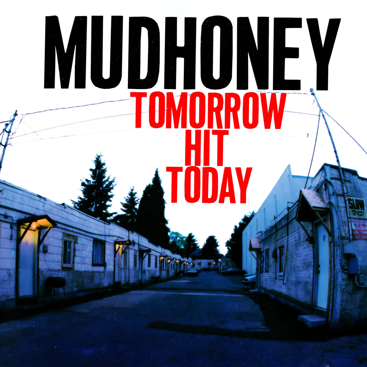Album cover for Mudhoney's 'Tomorrow Hit Today', featuring a blue-toned photograph of a deserted street between white buildings, with the band's name in black and the album title in red text.