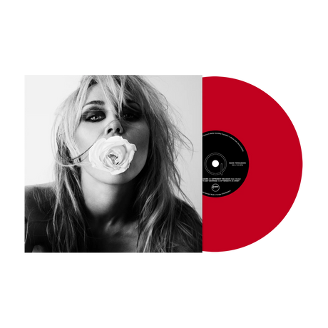 A vinyl record partially pulled from its sleeve, showing a black-and-white portrait of a woman holding a rose against a bright red record on a white background.