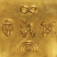 Gold embossed symbols on a textured gold background