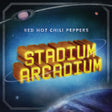 Album cover art for 'Stadium Arcadium' by Red Hot Chili Peppers, featuring bold 3D yellow block lettering with a red-orange shadow effect, set against a blue outer space background with planets and stars.