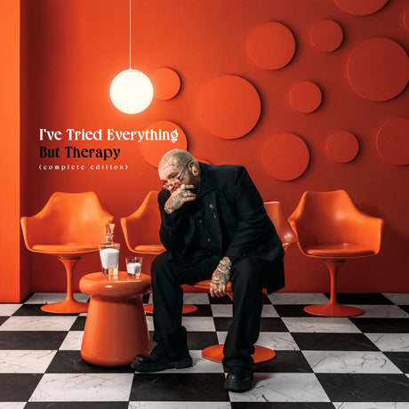 Person sitting in a modern room with orange chairs and a red wall, album cover for 'I've Tried Everything But Therapy'.