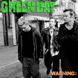 Black and white photo of four people on a street with 'Green Day' text at the top.