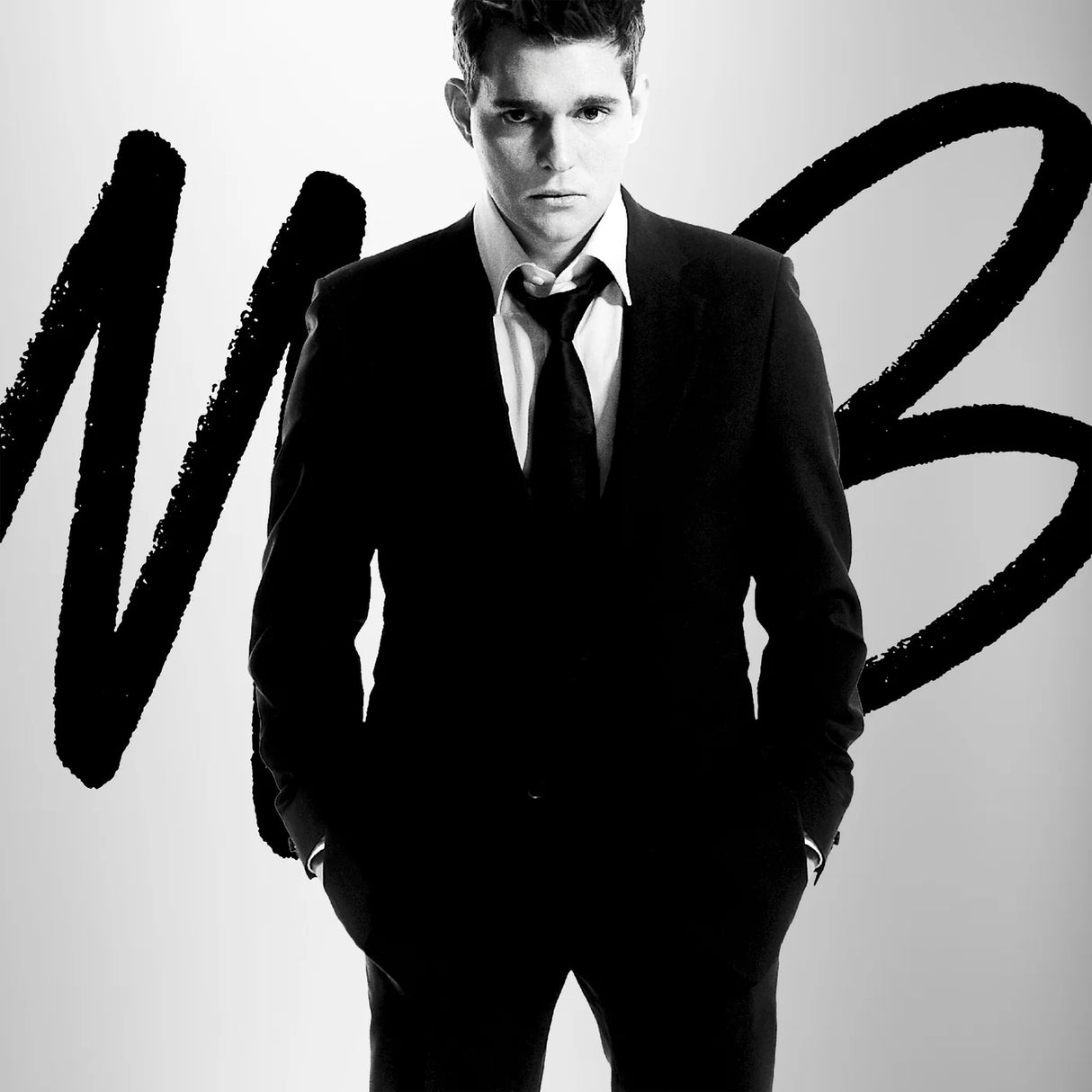 Man in a suit with a stylized 'MB' logo on a white background